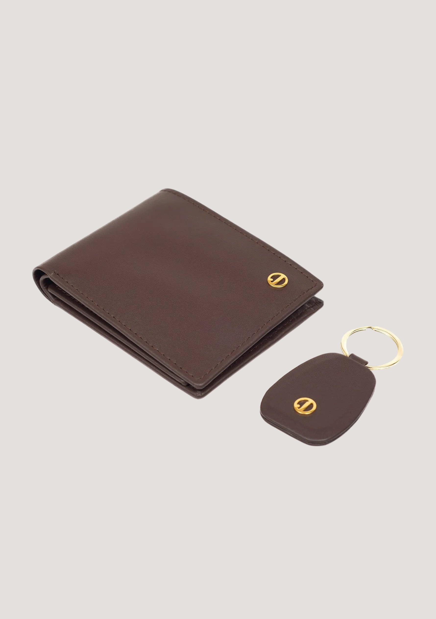Brown leather wallet and key fob set on a white background